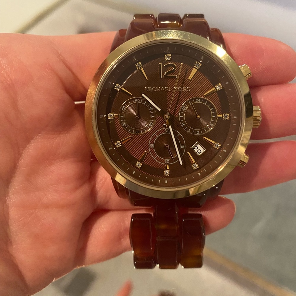 Micheal Kors tortoise shell watch with gold accent.